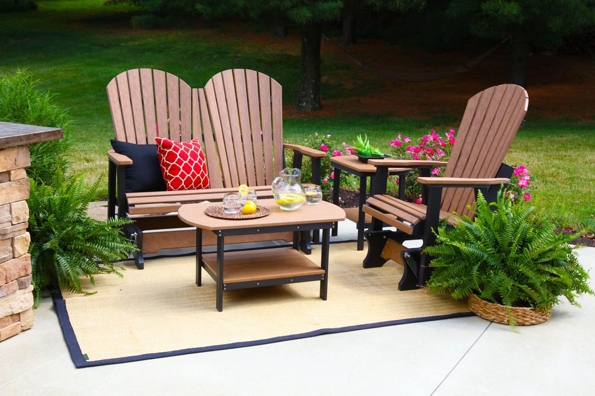 Glider poly furniture surrounded by plants.