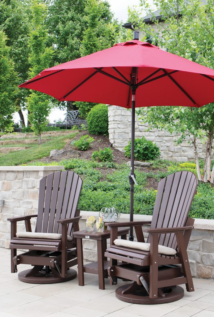 2 vinyl outdoor chairs under an umbrella
