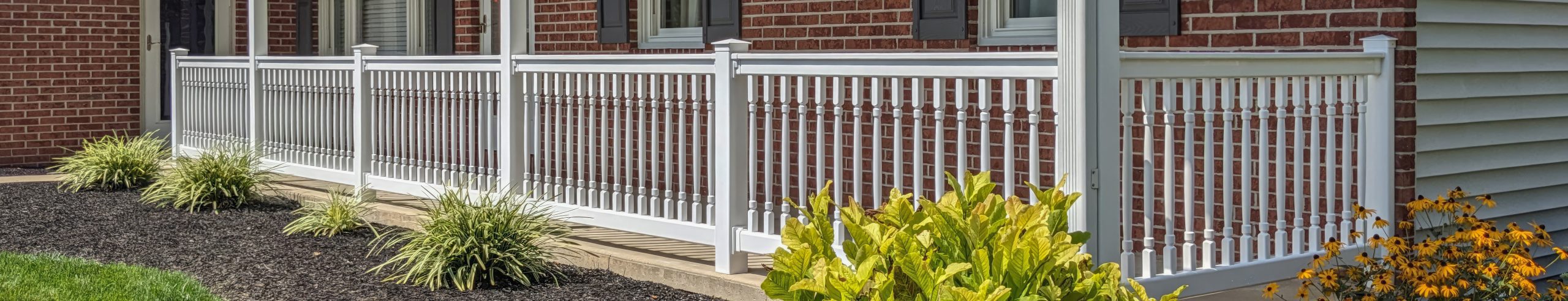 white vinyl railing around a porch