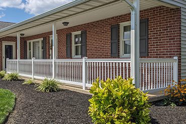 a porch with white vinyl railings